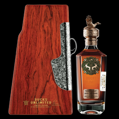 Ducks Unlimited logo overlaying a bottle of premium Kentucky Bourbon celebrating conservation efforts.